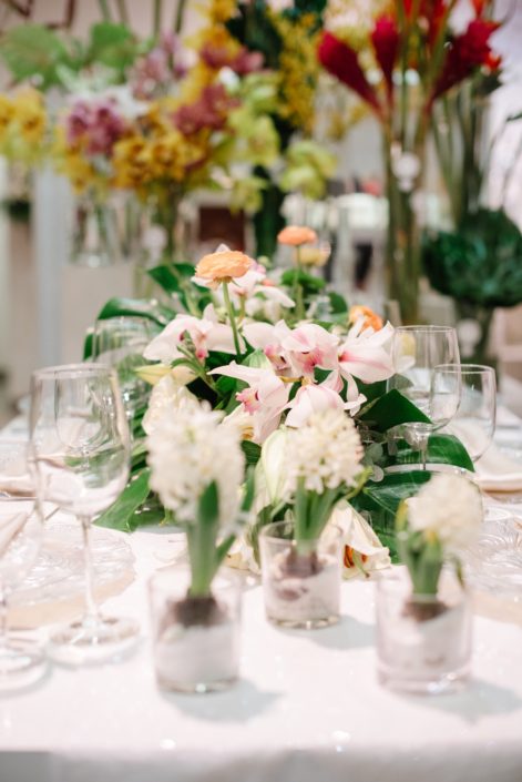 White hyacinth flowers and tropical cymbidium orchids in background of wedding table set up