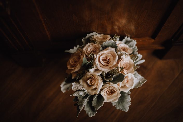 Bridesmaid bouquet designed with blush quicksand roses, dusty miller and seeded eucalyptus
