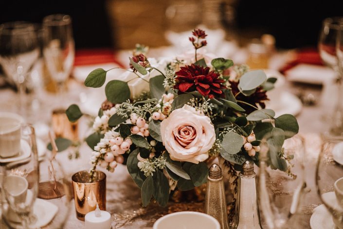 wedding compote style centerpipece designe with snowberry, pieris eucalyptus, burgundy dahlia and blush roses
