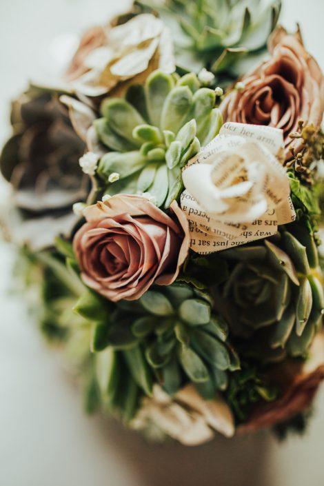 Close up photo of succulent and rose bouquet with paper flowers