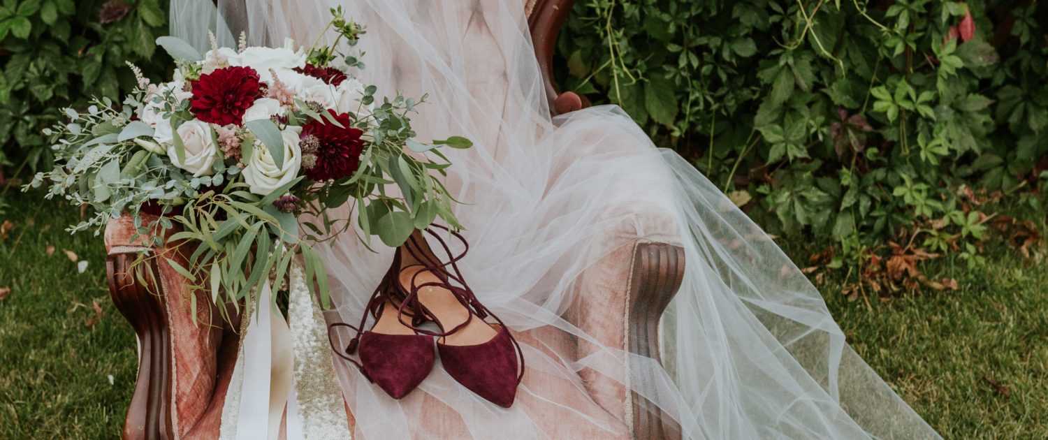 Antique dusty rose armchair with cathedral veil, burgudy heels and burgundy, blush and ivory bouquet with eucalyptus greenery