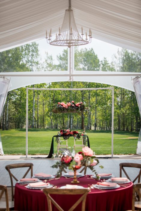 Clearspan wedding tent with chandelier and sweetheart table and wedding table in burgundy, black and coral