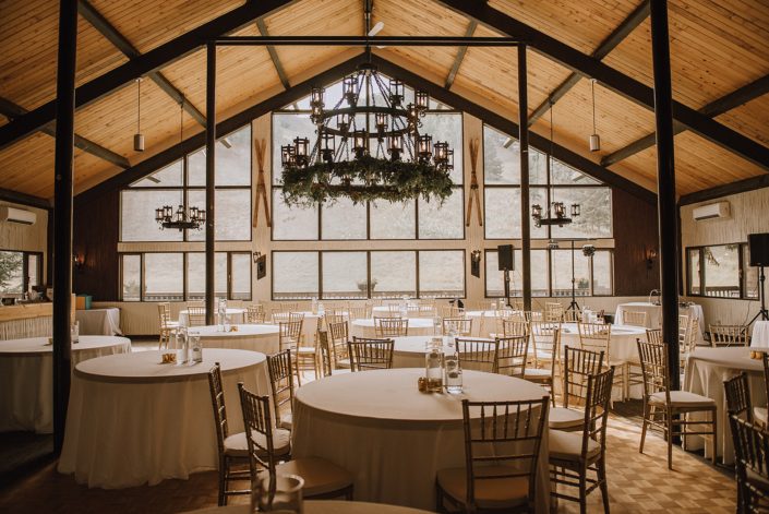 canyon ski resort wedding with fresh eucalyptus garland on chandelier and gold chiavari chairs