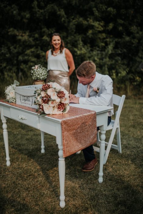 Singing table with bridesmaid and groomsman with bridal bouquet in rose gold ivory and blush with rose gold sequin table runner