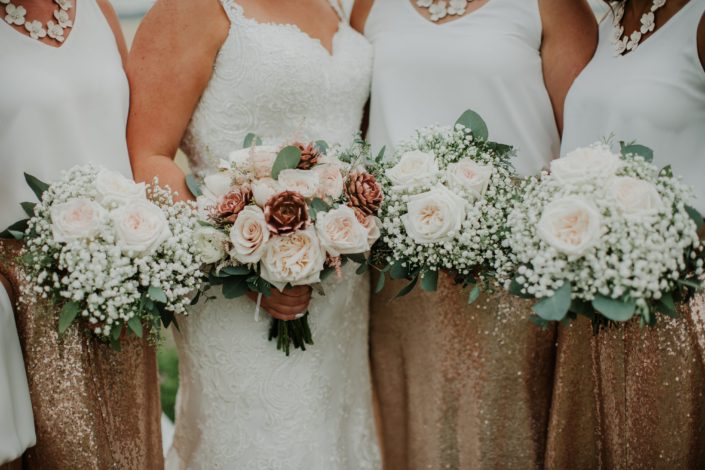 Bride and bridesmaids in rose gold sequin bridesmaid dresses with bouquets of rose gold succulents babies breath and white ohara garden roses