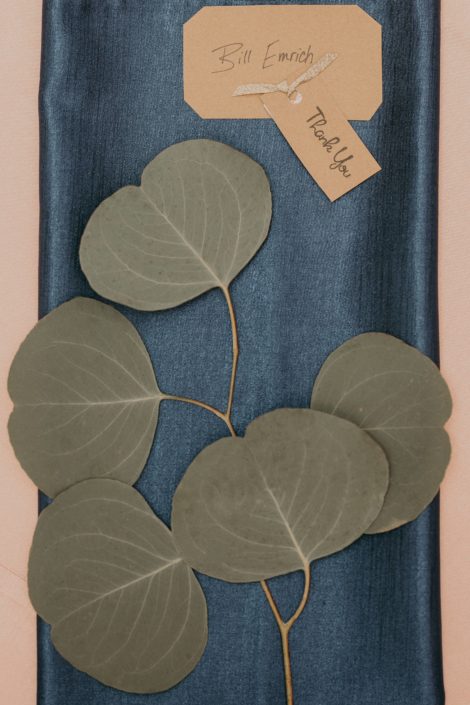 blue napkin with silver dollar eucalyptus sprig