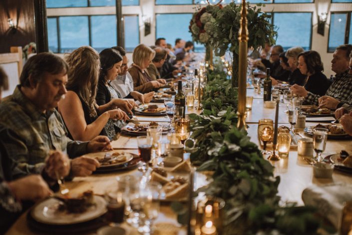 long table decor with mixed greenery garland and tall floral centerpieces on god candelabras at canyon ski resort in red deer alberta