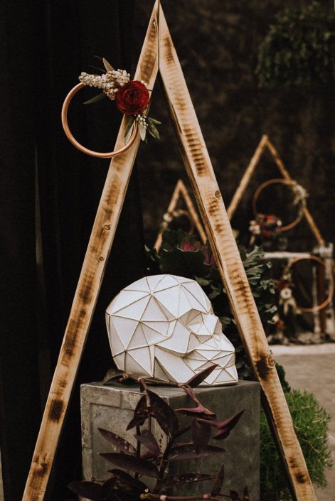copper hoop with florals with red ranunculus and white pieris and geometric skull on box