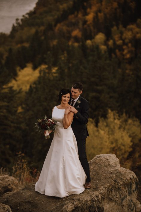 bride and groom at Canyon Ski Resort with burgundy and navy bridal bouquet