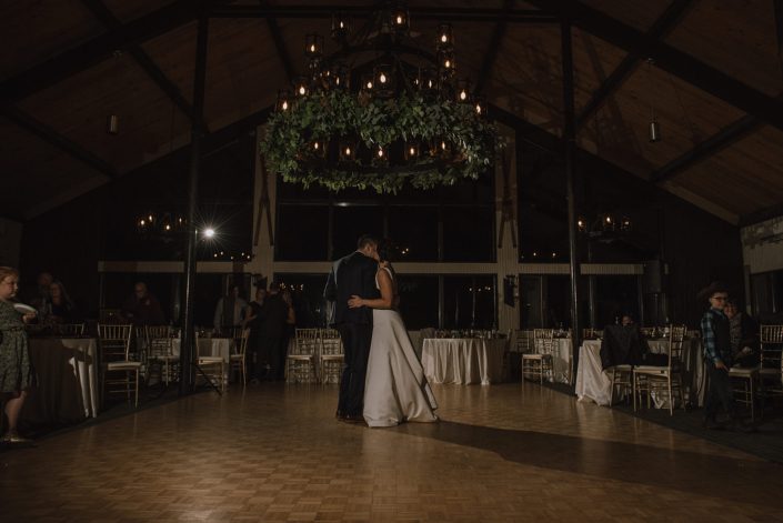 bride and groom dancing at Canyon ski resort underneath the chandelier decorated with a stunning mixed eucalyptus greenery garland