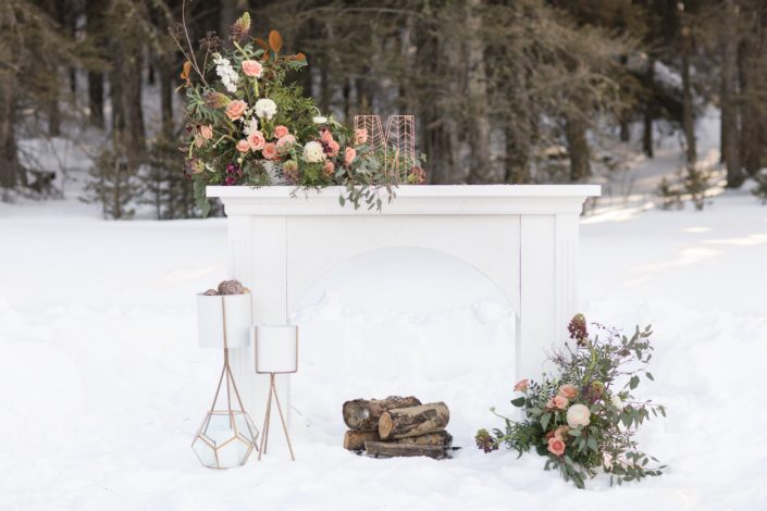 Elegant White Winter Wedding Styled Shoot - White mantle with gold geometric decorations with floral arrangements designed in each, blush and burgundy in winter
