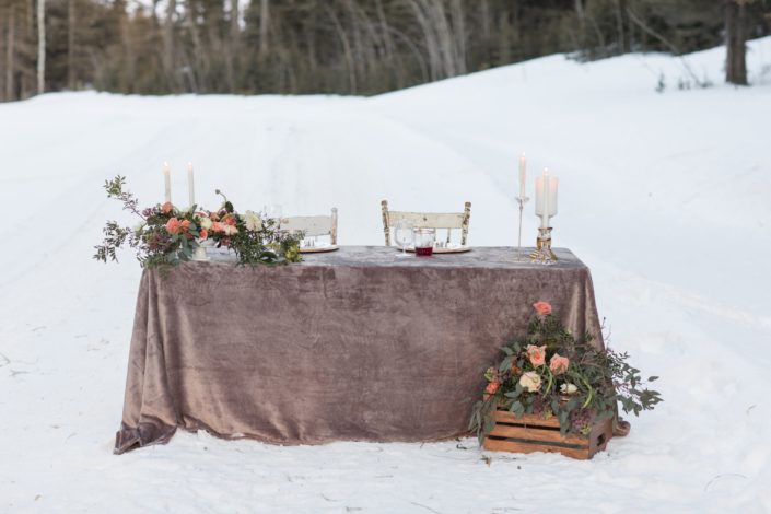 winter wedding sweetheart table with grey velvet linen and peach, blush and burgundy flowers