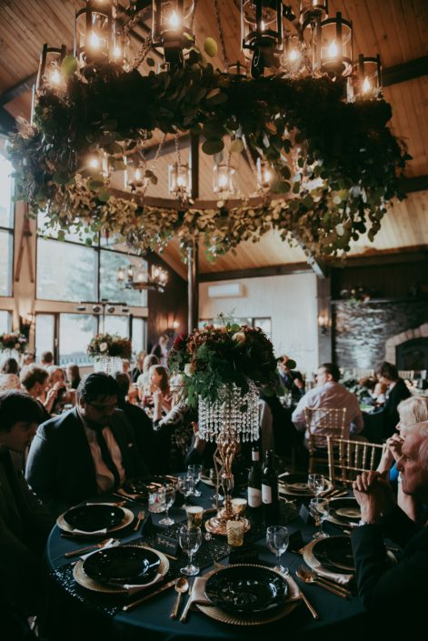 Elegant wedding at Canyon Ski Resort with mixed eucalyptus greenery garland on the chandlier and tall art deco style centerpieces