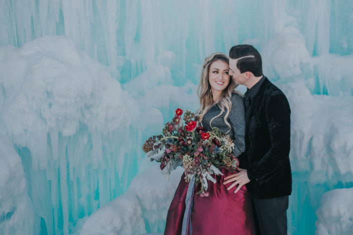 Ice Castle Engagement - An organic bridal bouquet designed for an engagement shoot at the edmonton ice castles with red tulips, burgundy ranunculus and red heleborus
