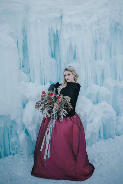 Engagement photos in winter at the edmonton ice castles with a loose and flowing organic bridal bouquet