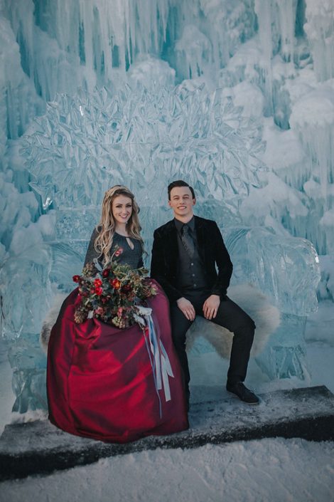 Ice castels engagement photos with a bridal bouquet of tulips, burgundy frittilaria and skimmia and trailing grey silk ribbons