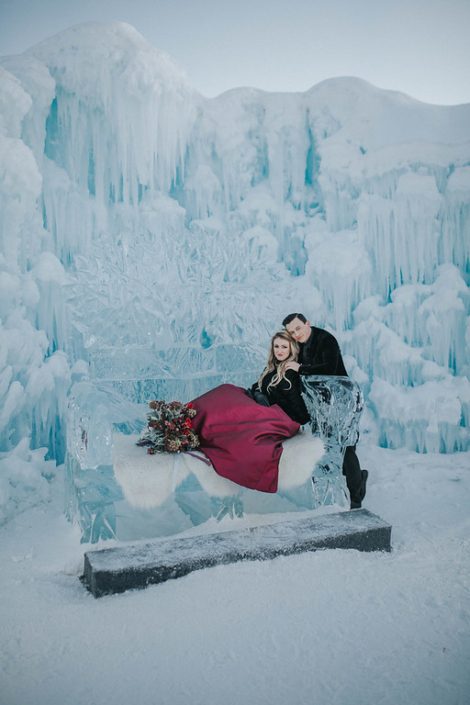 Ice couch at the edmonton ice castles for an engagement photoshoot with a bridal bouquet