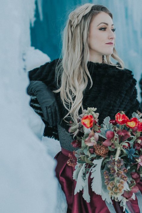 Engagement photos in winter at the ice castles with a bridal bouquet of dusty milller, red tulips and burgundy frittilaria