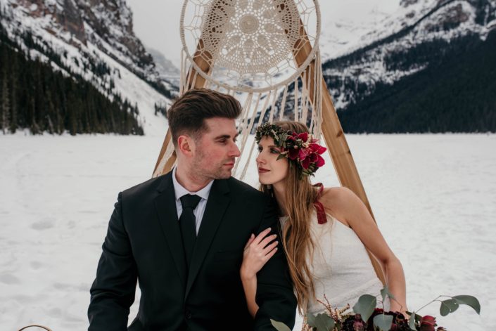bride and groom with a floral crown in boho winter photoshoot at lake louise