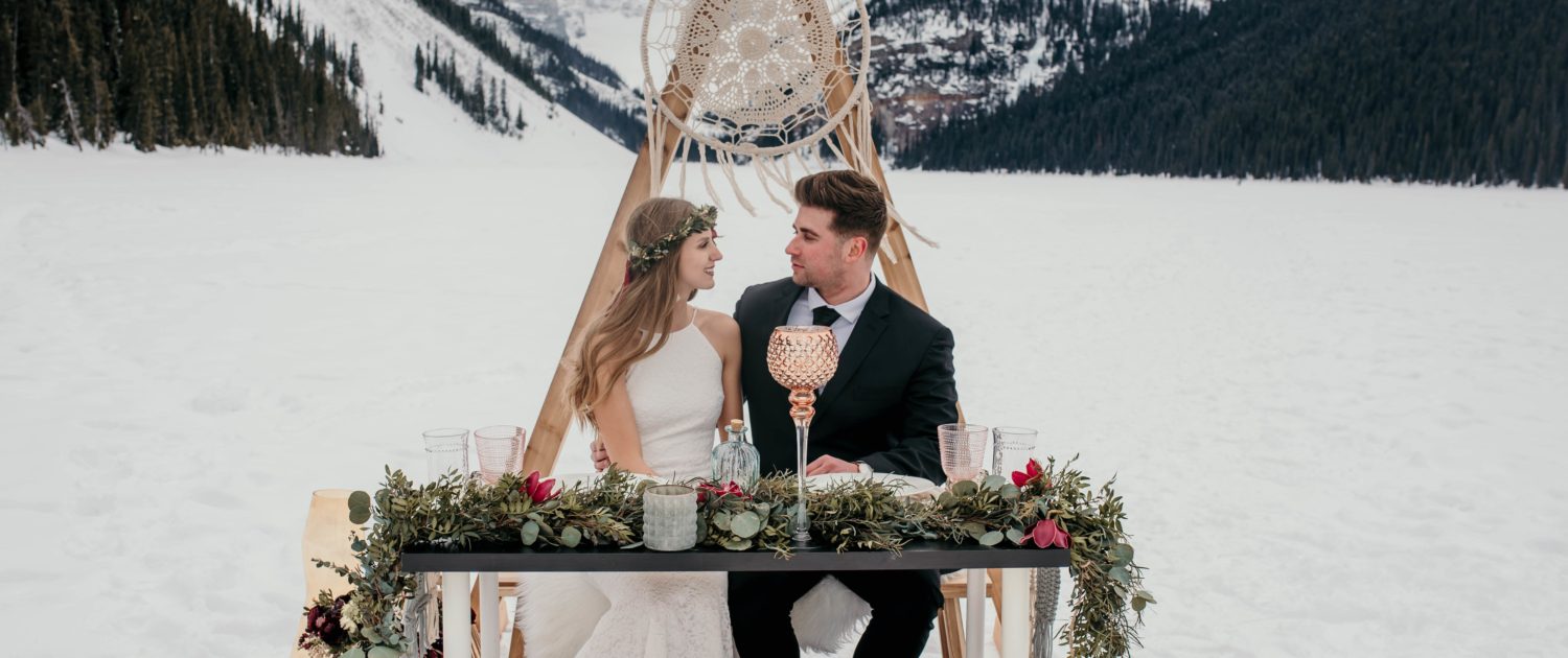 Boho style winter elopement at lake louise with macrame hoop and triangle archway