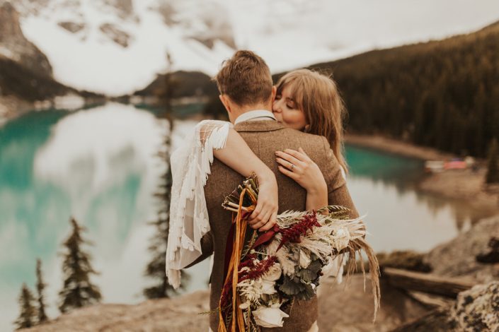 Moraine Lake Elopement Styled Shoot - Pampas grass bouquet made with ivory roses, red hanging amaranthus and ornamental kale tied with trailing ribbon.