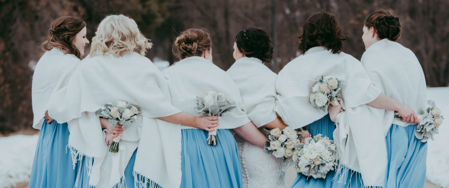 sky blue bridesmaid dresses in a winter wedding with white and grey bouquets