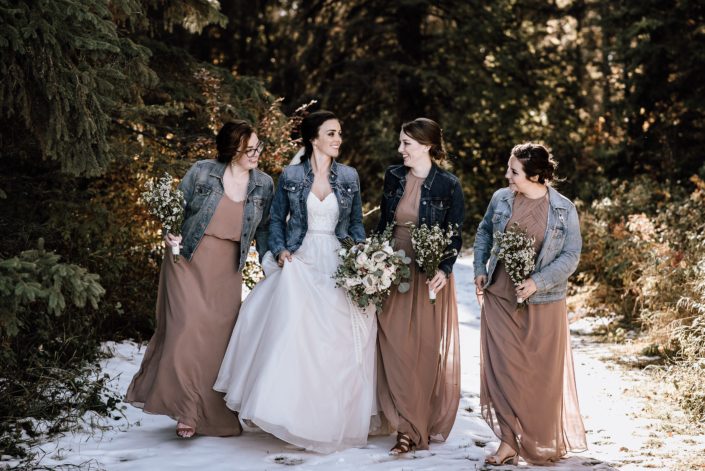 bride and bridesmaids in the winter with wax flower bouquets