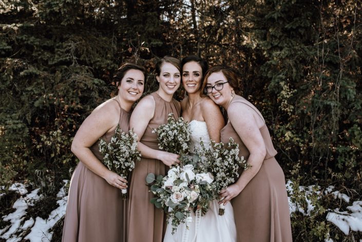 White Vintage Wedding - bride and bridesmaids in dusty rose dresses with wax flower bouquets