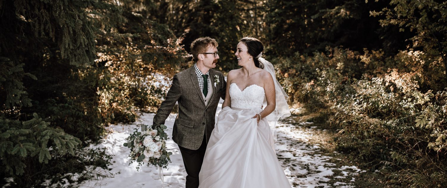 Bride and groom at a winter wedding with a white and blush bouquet and eucalyptus