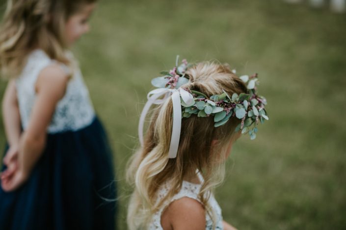 Flower girl wearing a tie-back flower crown made of eucalyptus and astilbe.