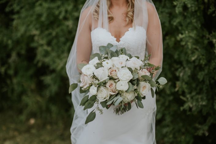 Brooke's blush and ivory bridal bouquet made of white o'hara garden roses, quicksand roses, playa blanca roses, ranunculus, astilbe, wax flower and eucalyptus greenery.