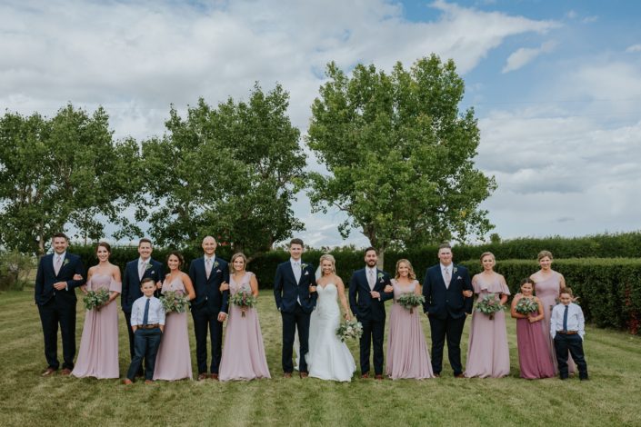 Brooke and Levi's Rustic Chic Blush Wedding party walking towards camera.
