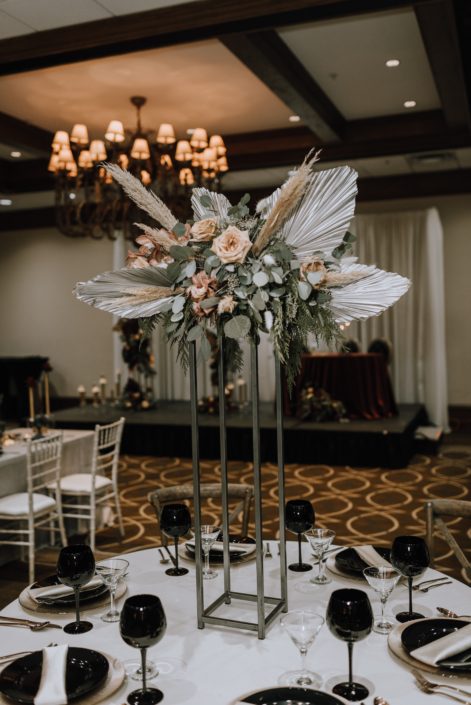 Cambridge Bridal Show 2020 - dramatic tall structural arrangement made of dyed metallic Anahaw palm leaves, pampas grass, blush roses and eucalyptus greenery.