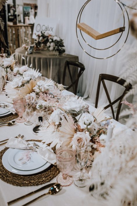 Table-scape at the With This Ring Bridal Gala featuring a long ivory and blush centrepiece with dried and fresh florals and foliage.