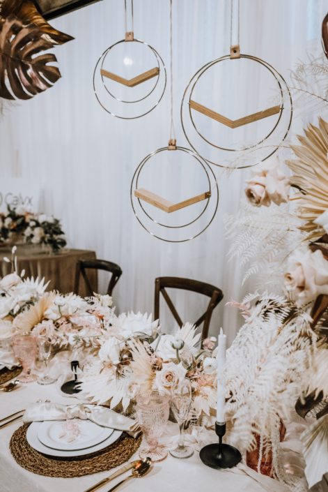 Display at the With This Ring Bridal Gala 2020 featuring ivory, blush pink, wood, and metallic gold accents with both fresh and dried botanicals.