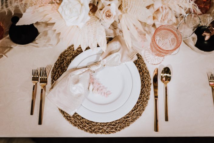 Table setting at the With This RIng Bridal Gala 2020 booth featuring metallic, wood, pink, ivory, cream and white tones and textures.