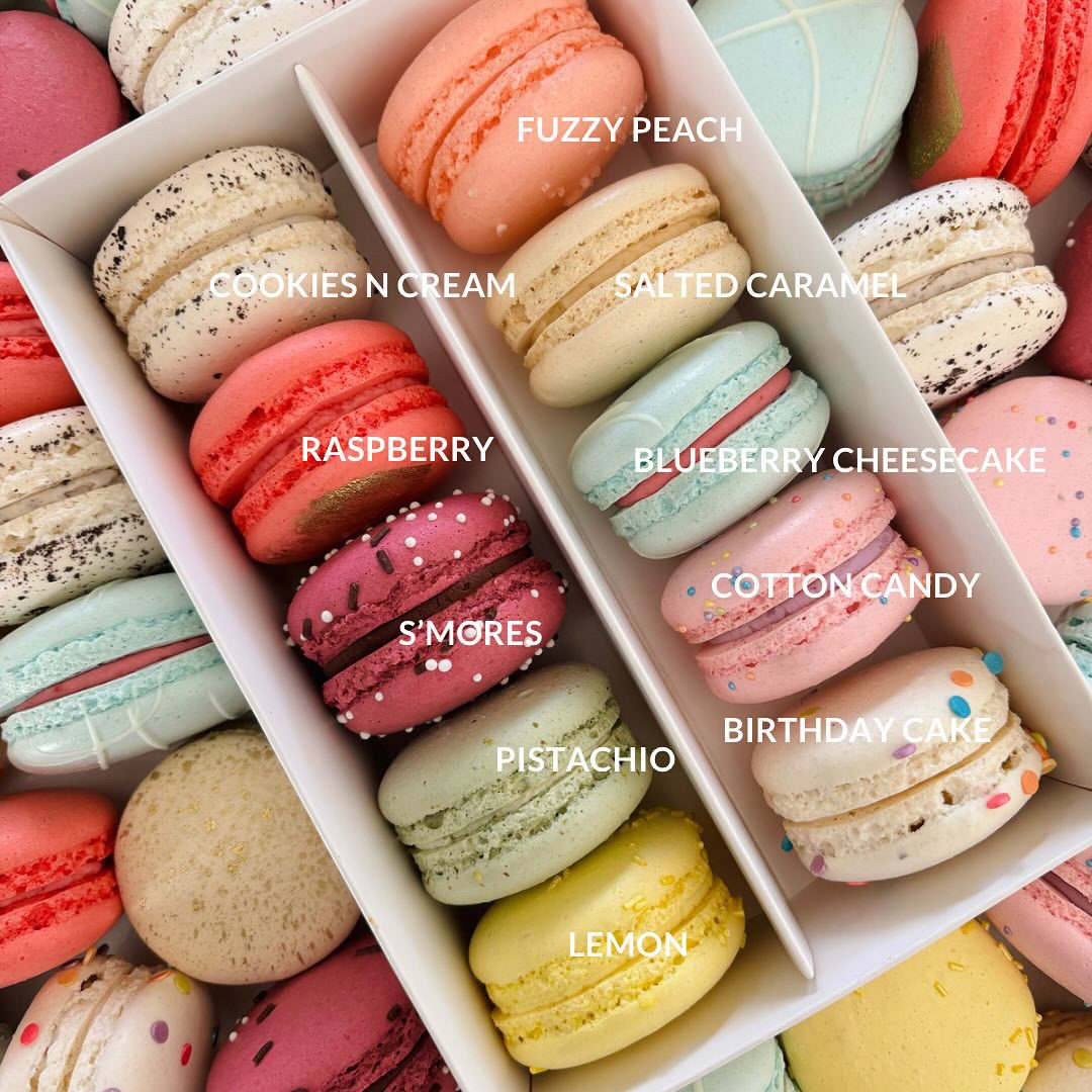 A colourful assortment of Queen Bee Macarons in a box, showing a variety of flavours.