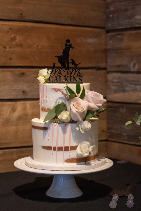 Naked cake decorated with pale pink quicksand roses, astilbe and seeded eucalyptus.