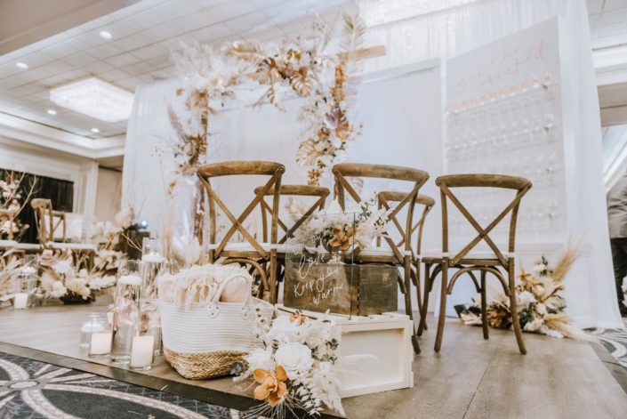 Let our love keep you warm sign, blankets, candles and flower arrangements made of dried leaves and branches, pampas grass, orchids and white roses.
