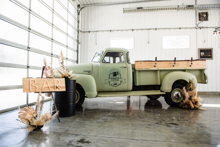 The Prohibition Pickup surrounded by dried floral arrangements.
