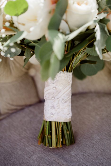 Cream and Blush Vintage Chic bridal bouquet handle wrapped with blush satin and an ivory lace overlay with pearl pins.