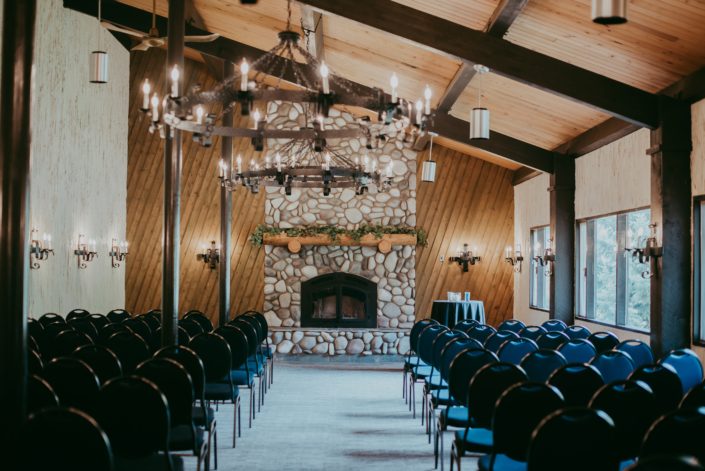 Canyon Ski Resort Ceremony Room Stone Fireplace mantel covered with a eucalyptus greenery garland.