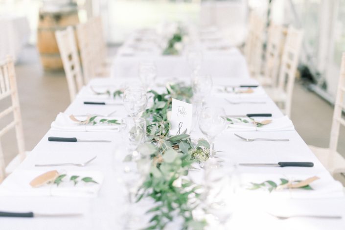 Simple and timeless fresh greenery garland centrepiece.
