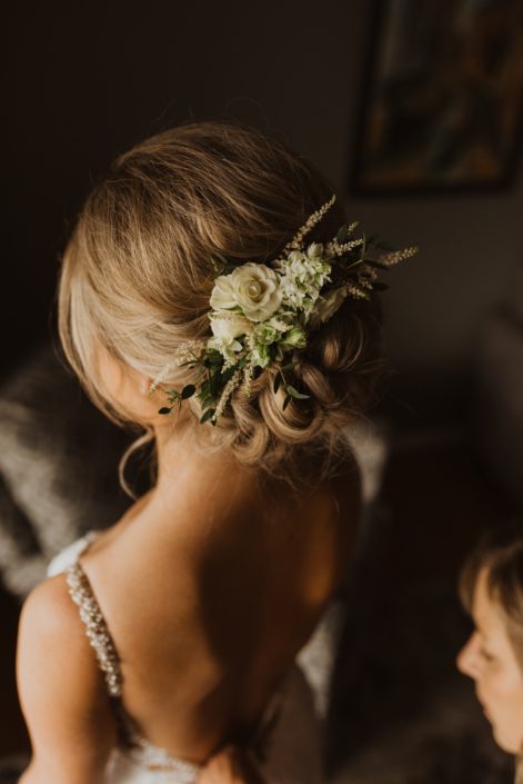 Vintage inspired hair flowers made with white lisianthus, spray roses and astilbe accented by grey toned greenery.