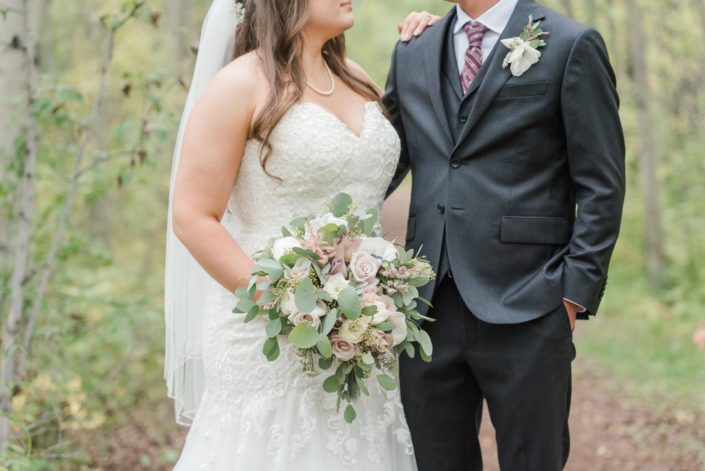Amber and Mike with elegant mauve and ivory bridal bouquet featuring panda anemones, quicksand roses, amnesia roses, ranunculus and eucalyptus.