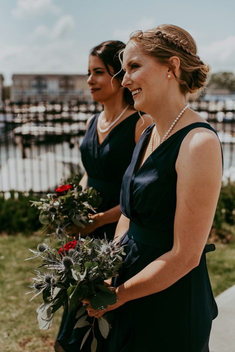 Tanya and Sean's RCMP wedding bridesmaids wearing navy blue and holding bouquets made of black baccara roses, eryngium and eucalyptus