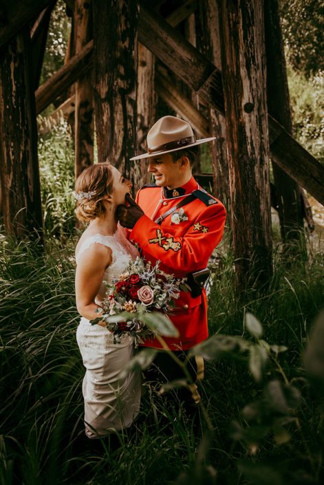 bride and groom Tanya and Sean RCMP wedding - with bridal bouquet designed with black baccara roses, amnesia roses, navy eryngium, burgundy dahlias, rose gold succulents and eucalyptus