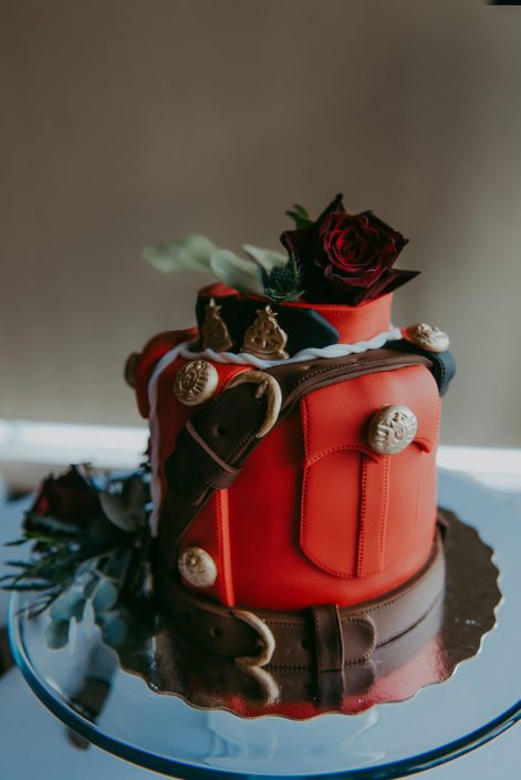 RCMP wedding cake with cake flowers such as eryngium and black baccara roses