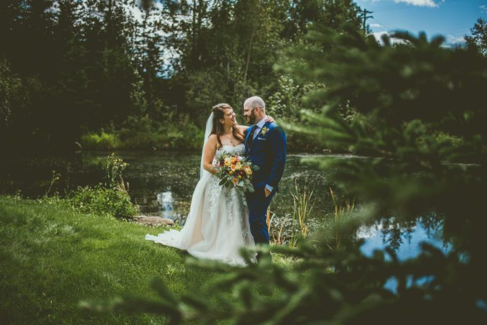 Bride and groom at Pine and Pond with mustard yellow bridal bouquet.
