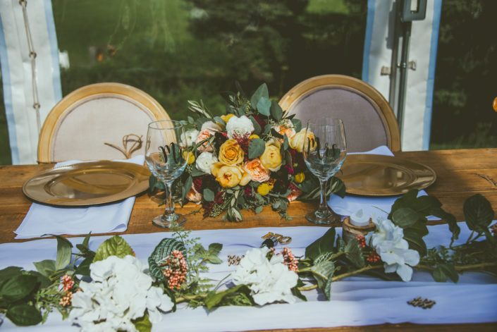 Head table with mustard yellow bridal bouquet.